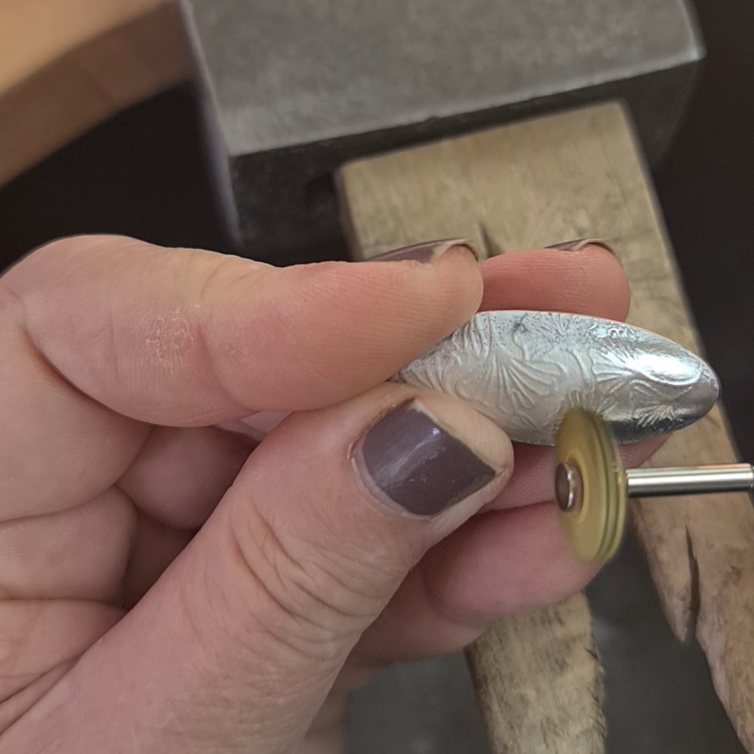 image shows the oval pendant being polished